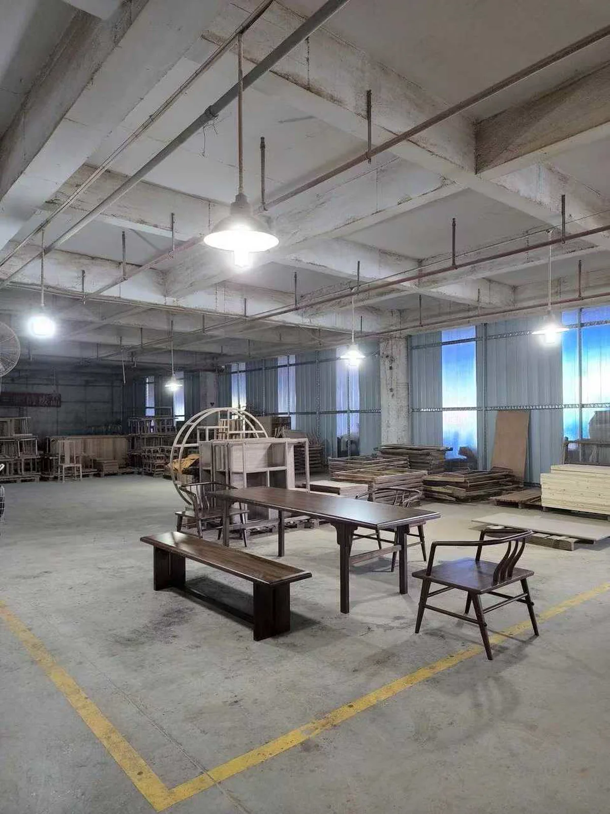 Furniture workshop floor with walnut-related pieces and packing areas