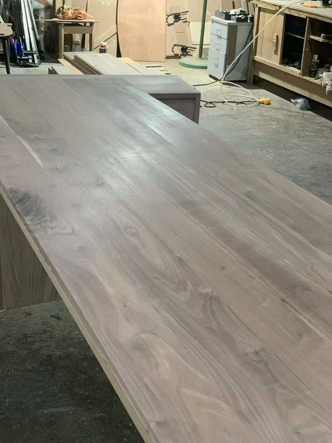 Solid American black walnut panels prepared in a furniture workshop