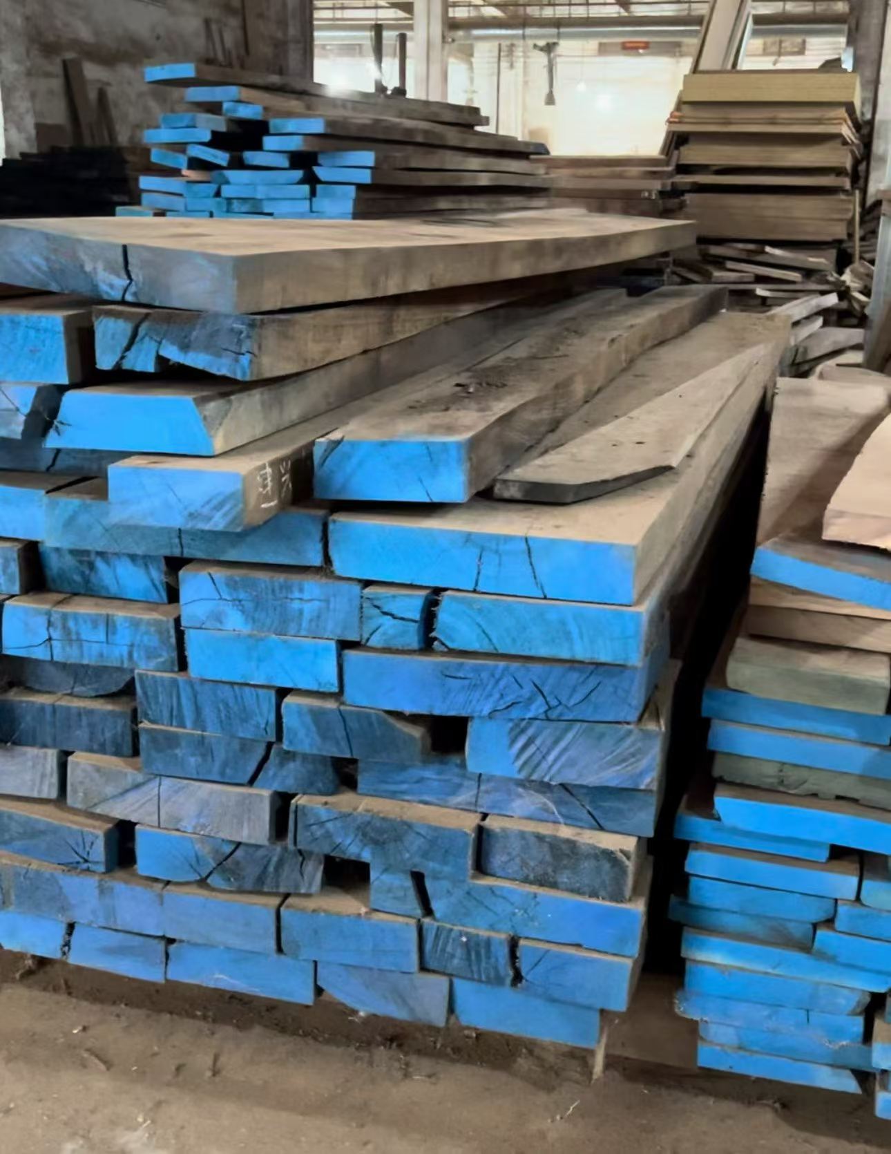 Wood stock stacked and staged in a workshop